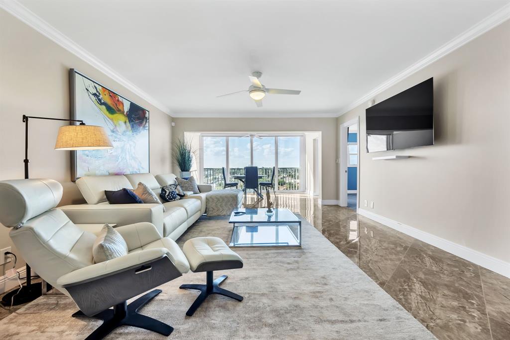 615 North Riverside Drive, Unit 702 Pompano Beach, FL 33062 - Photo 10 of 38 a living room with furniture and a flat screen tv