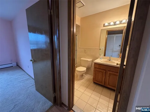 a bathroom with a glass shower door