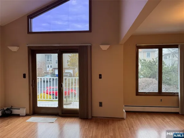 a view of an entryway with wooden floor and windows
