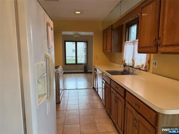 a kitchen with stainless steel appliances a sink and cabinets