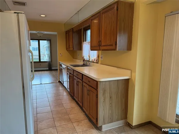 a kitchen with stainless steel appliances a sink stove and cabinets