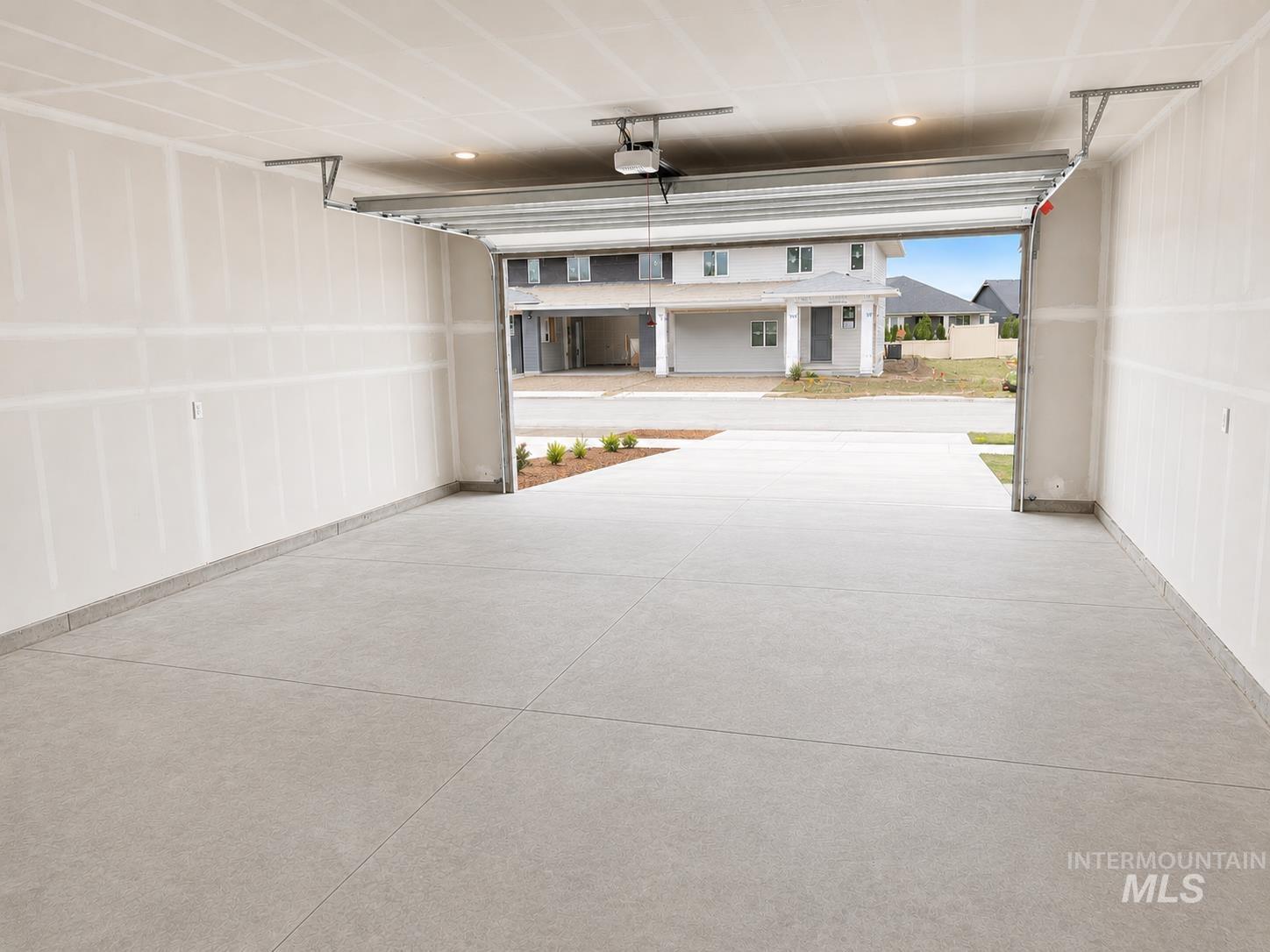 8098 West Fern Street Eagle, ID 83616 - Photo 19 of 22 Spacious garage featuring a concrete floor, unfinished drywall, and an automatic garage door opener