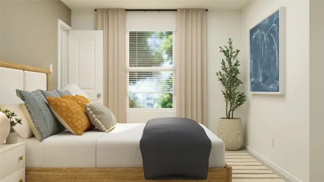 a bedroom with a bed and a window