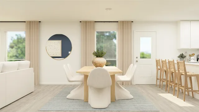 a dining room with furniture and a large window