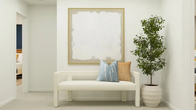 a bedroom with a bed and a potted plant