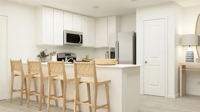 a kitchen with a sink cabinets and a refrigerator