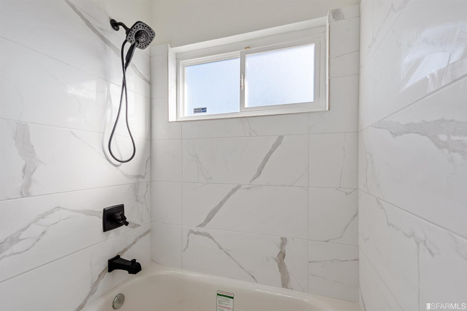 5955 Hayes Street Oakland, CA 94621 - Photo 17 of 20 a bathroom with a glass shower door
