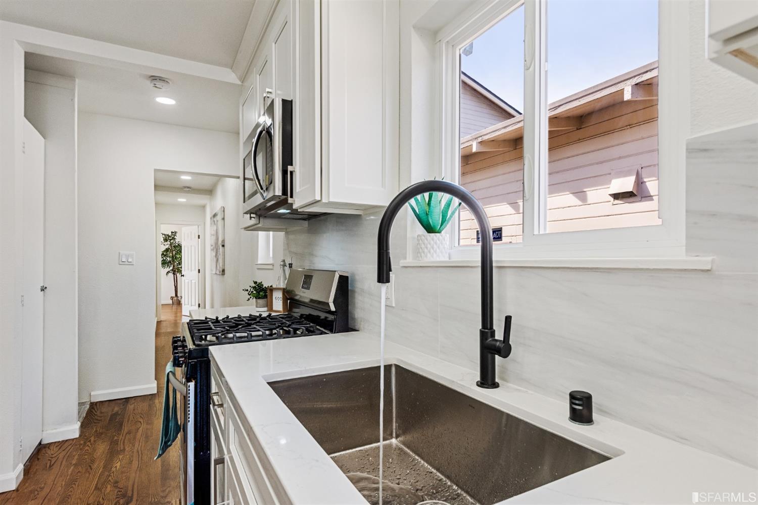 5955 Hayes Street Oakland, CA 94621 - Photo 6 of 20 a kitchen with stainless steel appliances granite countertop a sink a stove and a refrigerator