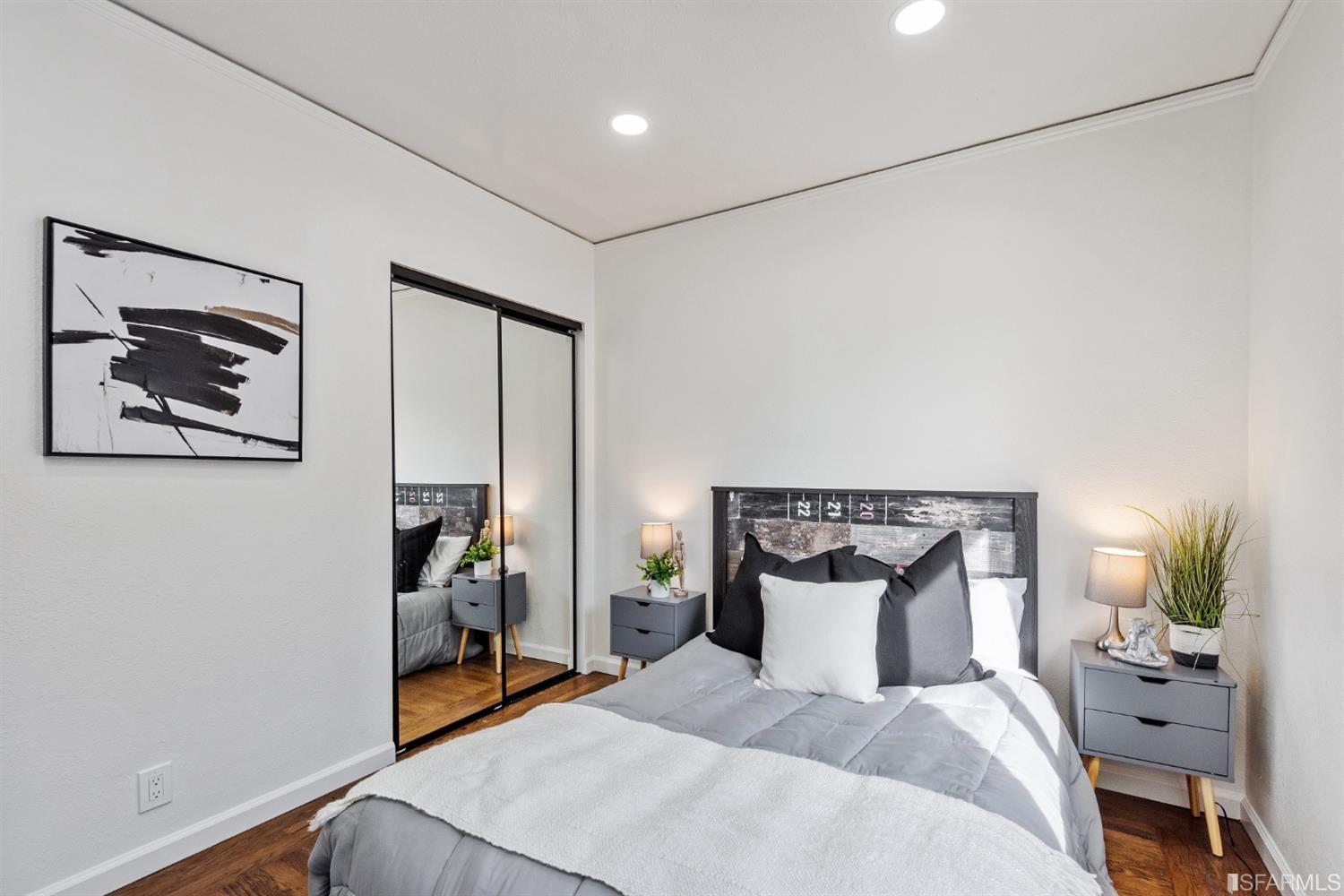 5955 Hayes Street Oakland, CA 94621 - Photo 9 of 20 a bedroom with a bed and a potted plant on the dresser