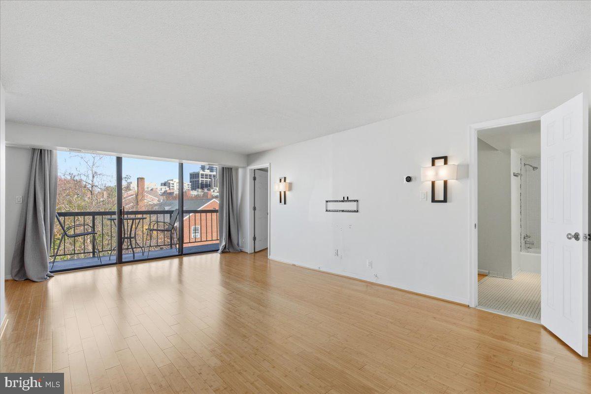 1401 North Rhodes Street, Unit 503 Arlington, VA 22209 - Photo 1 of 17 wooden floor in an empty room with a window