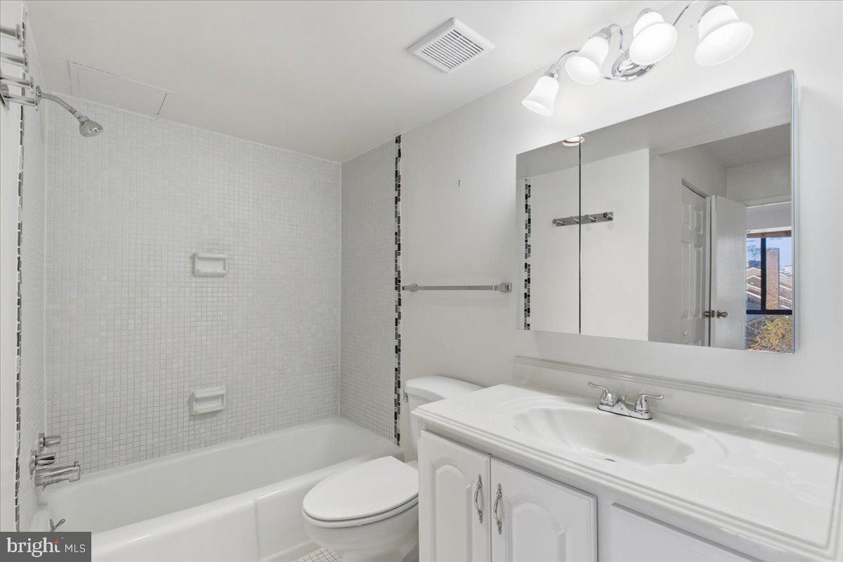 1401 North Rhodes Street, Unit 503 Arlington, VA 22209 - Photo 11 of 17 a bathroom with a sink a toilet and shower