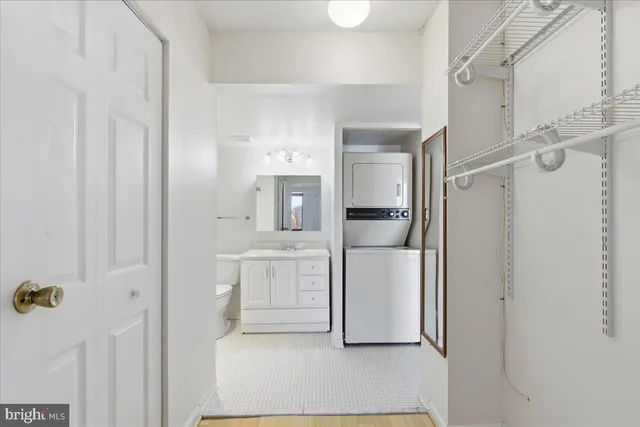 a kitchen with white cabinets and refrigerator