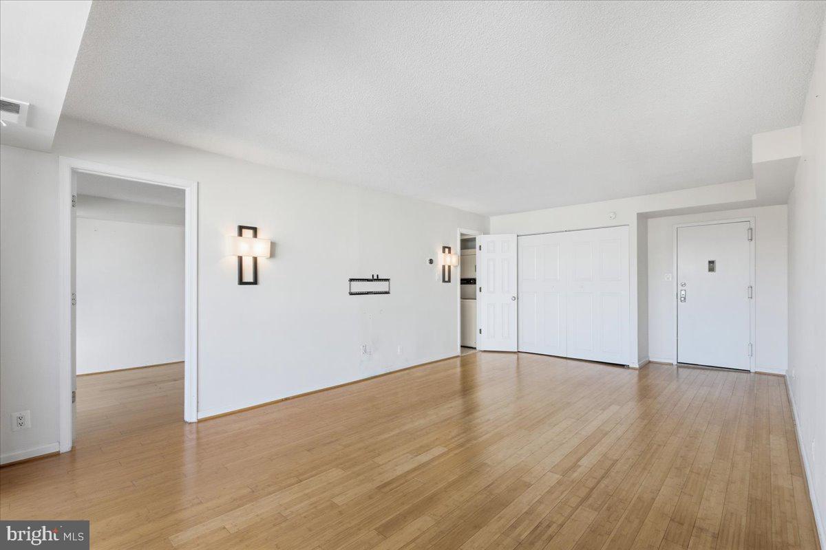 1401 North Rhodes Street, Unit 503 Arlington, VA 22209 - Photo 2 of 17 a view of an empty room with wooden floor