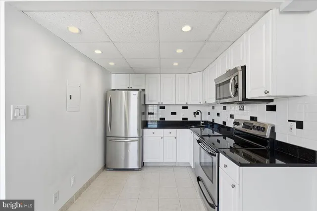 a kitchen with stainless steel appliances a refrigerator stove microwave and cabinets