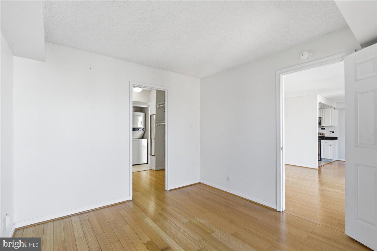 1401 North Rhodes Street, Unit 503 Arlington, VA 22209 - Photo 8 of 17 a view of an empty room with wooden floor and a window