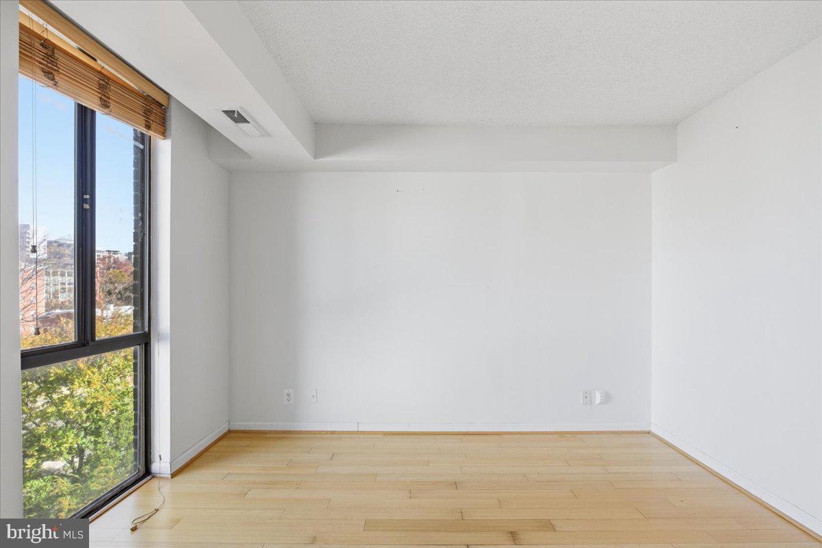 1401 North Rhodes Street, Unit 503 Arlington, VA 22209 - Photo 9 of 17 a view of an empty room with a window
