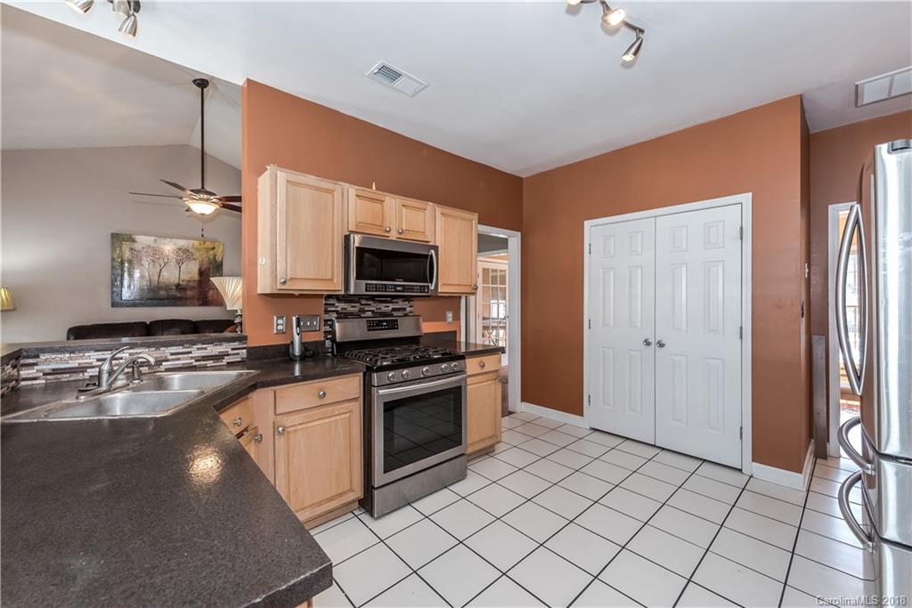 701 Monticello Drive Fort Mill, SC 29708 - Photo 5 of 21 a kitchen with stainless steel appliances granite countertop a stove a sink and a refrigerator
