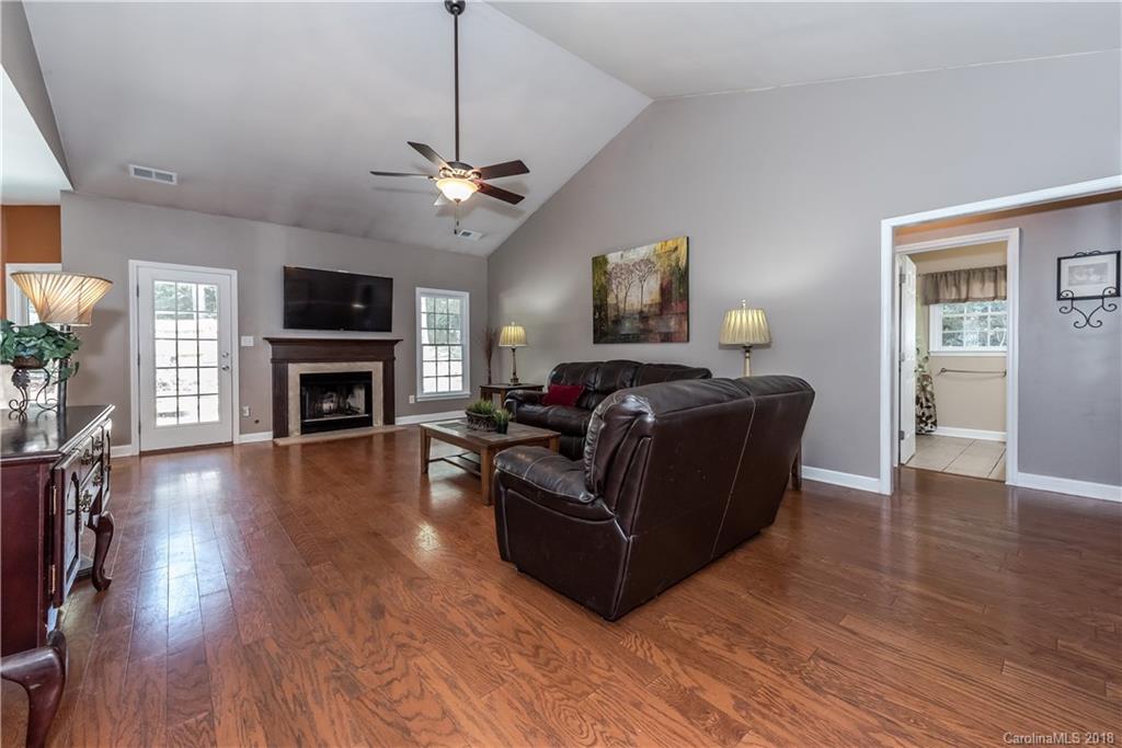 701 Monticello Drive Fort Mill, SC 29708 - Photo 7 of 21 a living room with furniture a fireplace and a flat screen tv