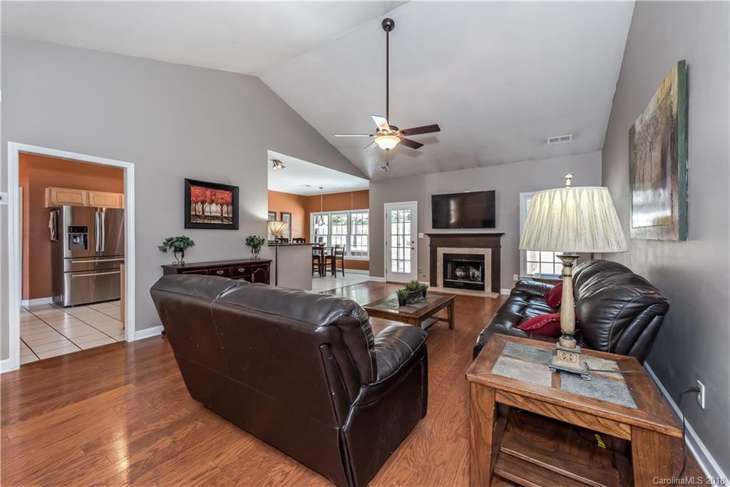 701 Monticello Drive Fort Mill, SC 29708 - Photo 8 of 21 a living room with furniture a fireplace and a flat screen tv