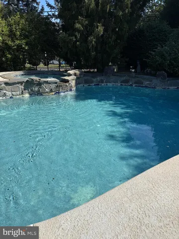 a view of swimming pool and outdoor seating