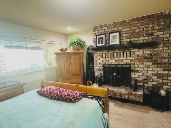 a spacious bathroom with a granite countertop sink mirror and bathtub