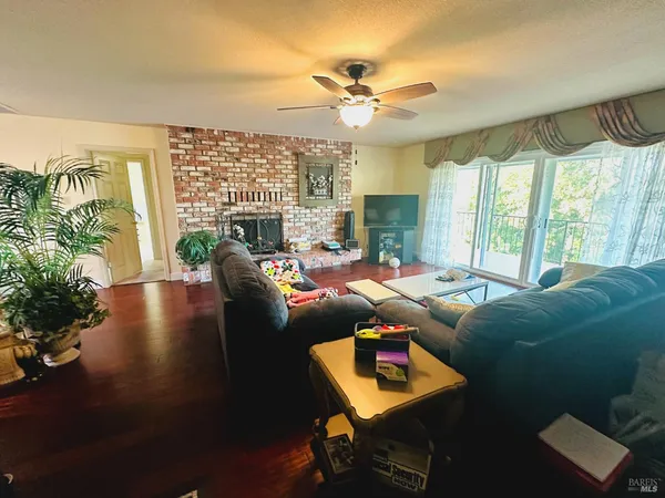 a living room with furniture and a floor to ceiling window