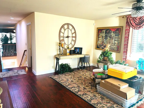 a living room with furniture and a wooden floor
