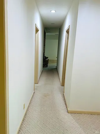 a view of an empty room with a fireplace and a window