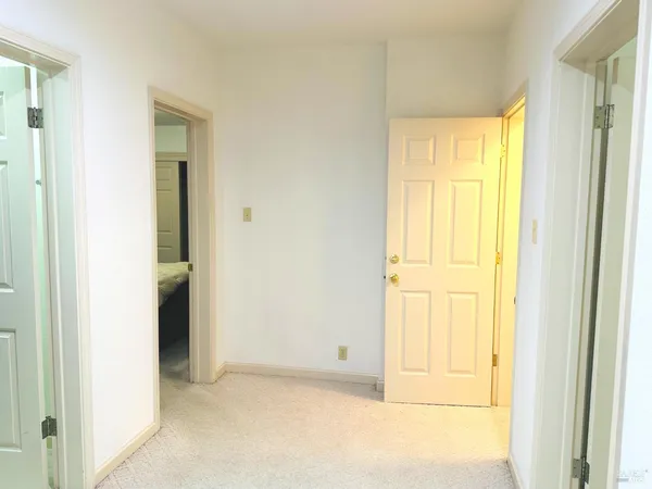 a view of a room with a window and a ceiling fan