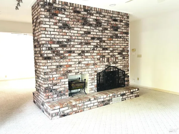 a view of a balcony and a floor to ceiling window next to a yard