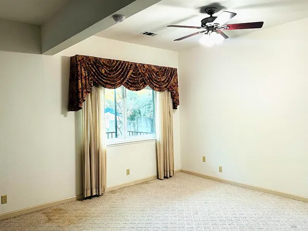 a view of a porch with wooden floor and iron fence