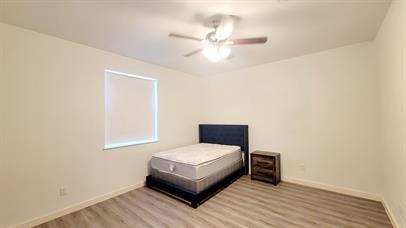 1709 Sycamore Street, Unit 1 Commerce, TX 75428 - Photo 13 of 17 a bedroom with a bed and window