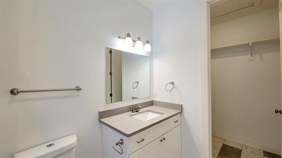 1709 Sycamore Street, Unit 1 Commerce, TX 75428 - Photo 16 of 17 a bathroom with a sink and a mirror