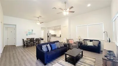 a living room with furniture and wooden floor