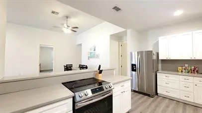 a kitchen with stainless steel appliances a refrigerator and a stove