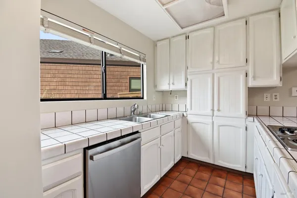 a kitchen with cabinets and a stove