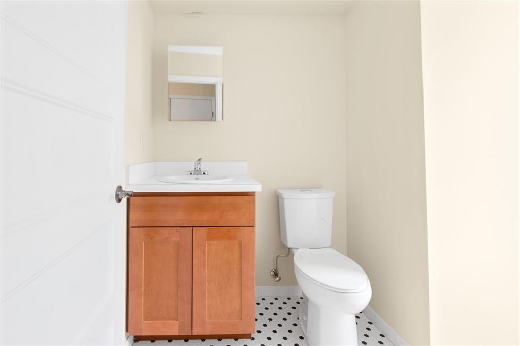 15 Stanton Road Brooklyn, NY 11235 - Photo 12 of 29 a bathroom with a sink a toilet and mirror