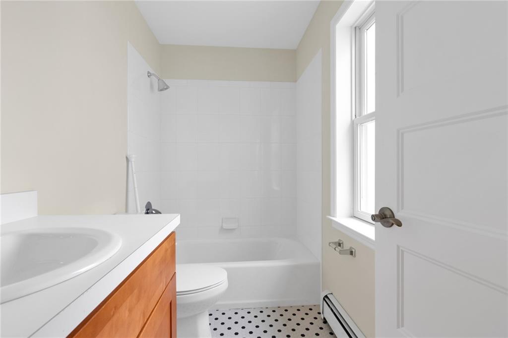 15 Stanton Road Brooklyn, NY 11235 - Photo 18 of 29 a bathroom with a bathtub shower sink vanity and toilet