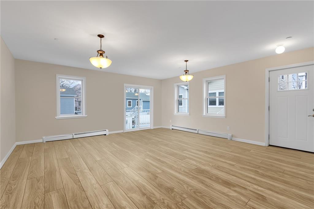15 Stanton Road Brooklyn, NY 11235 - Photo 2 of 29 an empty room with windows and wooden floor