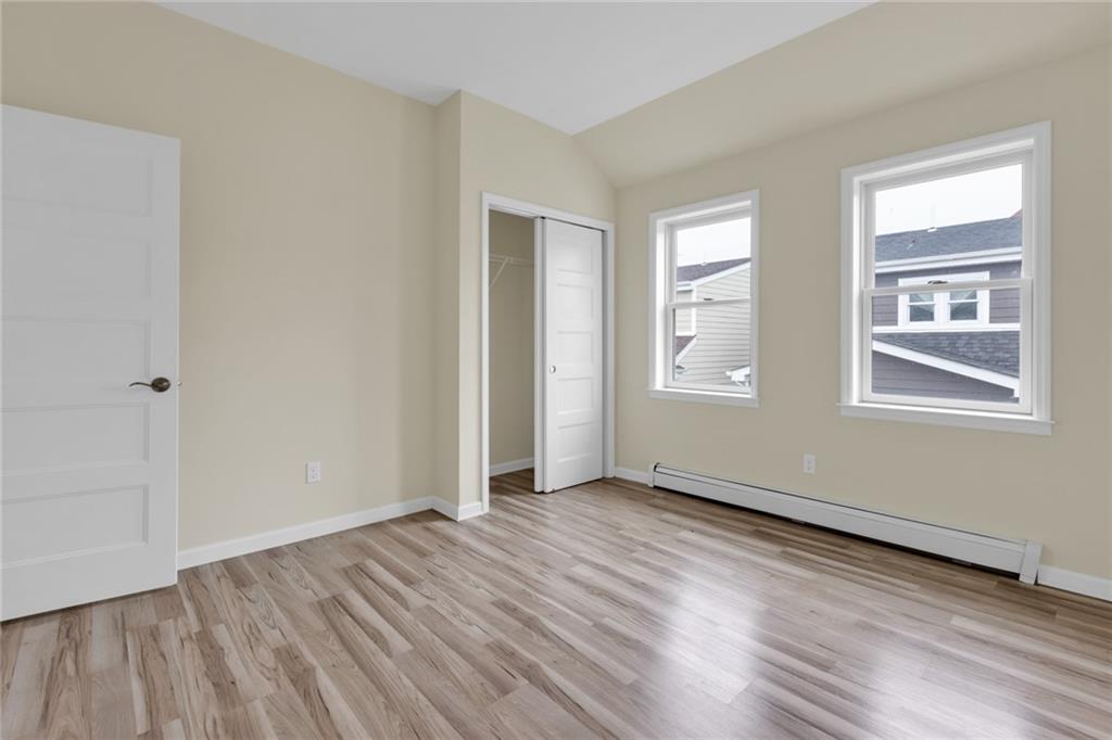 15 Stanton Road Brooklyn, NY 11235 - Photo 7 of 29 an empty room with wooden floor and windows