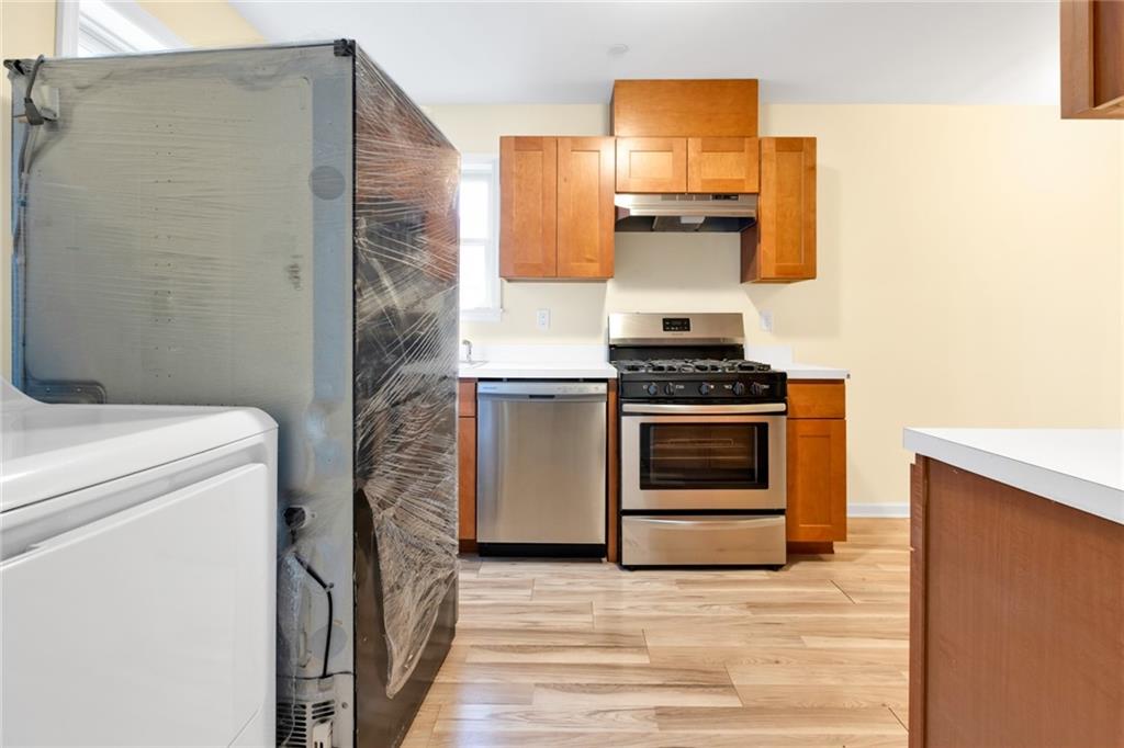 15 Stanton Road Brooklyn, NY 11235 - Photo 9 of 29 a kitchen with a stove and a refrigerator