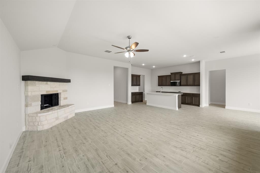 228 Shepards Street Godley, TX 76044 - Photo 17 of 27 a view of kitchen with a stove and a fireplace