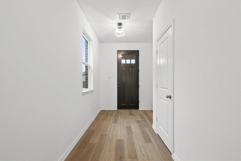 1663 Gracehill Way Forney, TX 75126 - Photo 4 of 30 a view of a room with wooden floor and a bathroom