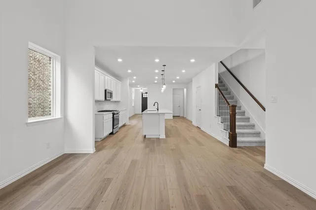 a view of kitchen with sink and wooden floor