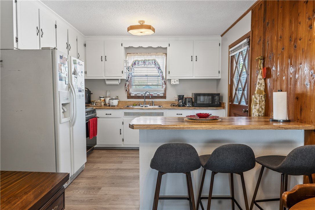 155 Farrs Bridge Road Pickens, SC 29671 - Photo 11 of 19 This cozy kitchen features a practical layout with ample storage and a charming breakfast bar.