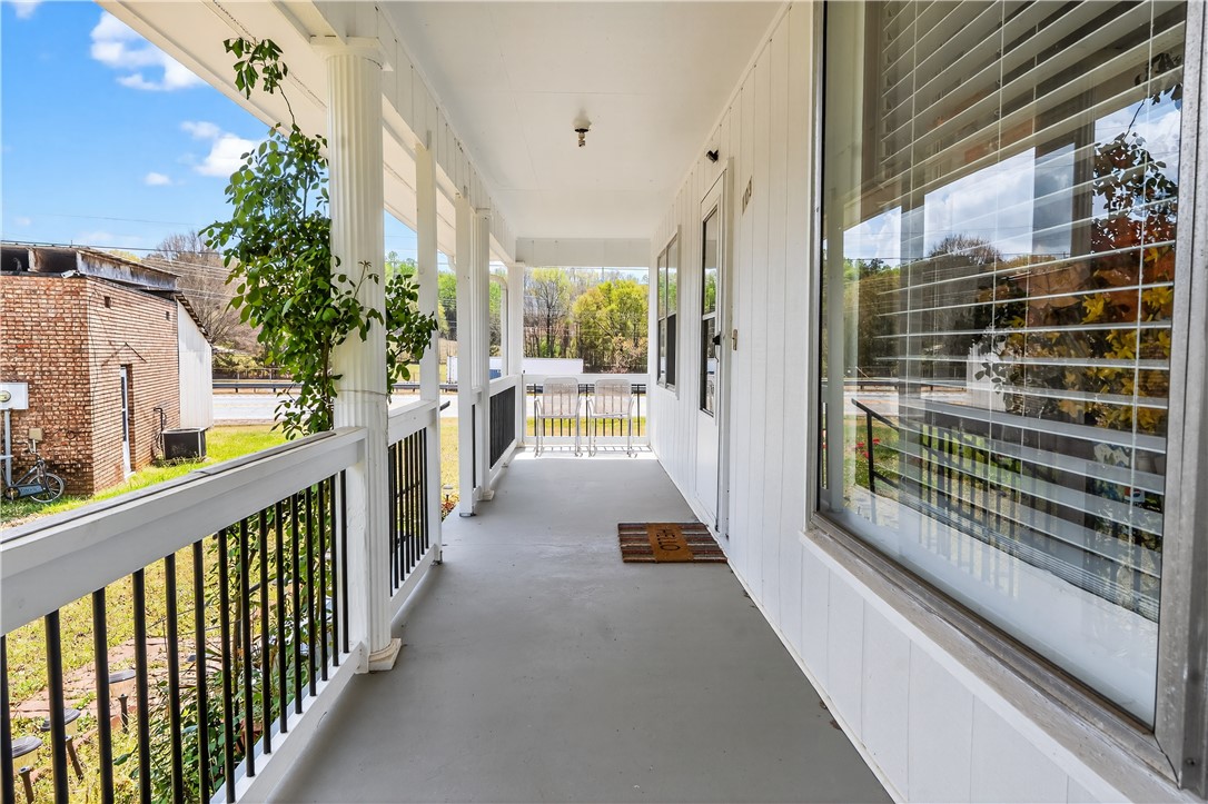 155 Farrs Bridge Road Pickens, SC 29671 - Photo 3 of 19 Relax on the inviting porch, where peaceful moments and gentle breezes await.