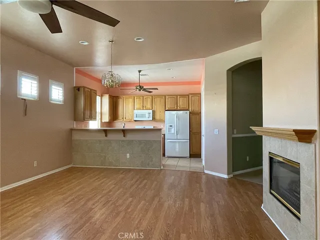 a view of a kitchen with a sink and a fireplace