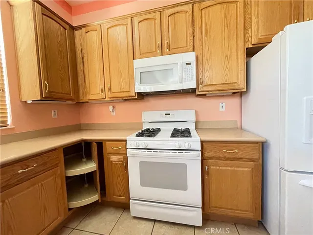 a kitchen with granite countertop cabinets stainless steel appliances and sink