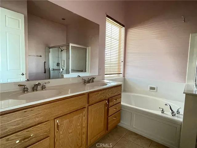 a bathroom with a tub sink and mirror