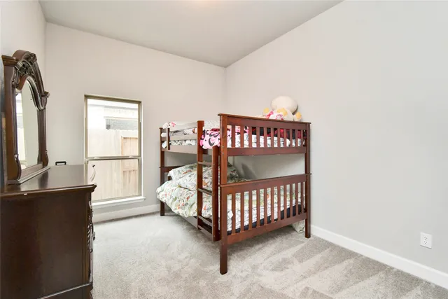 a bedroom with a bed and a night stand